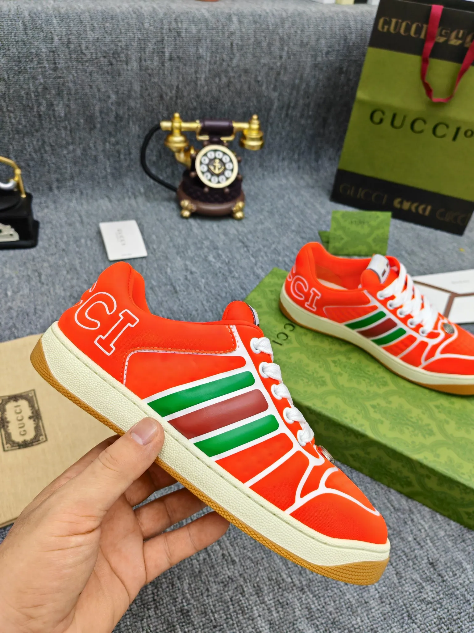 Factory price 600💰Screener series embellished web sneakers. This item is from the Gucci Lido series. Its design is inspired by the summer style and beach clubs of the Italian coast. The Screener series of sneakers draws inspiration from classic sneakers from the 1970s and takes its name from a special defensive move in sports. This shoe from the 2024 Pre-Fall collection is crafted from yellow rubber, a technical and malleable opaque material, with striped webbing on the sides and an embossed Gucci printed logo on the heel. Yellow rubber, opaque and technological in appearance. Red and green webbing decorated with metal Double G oval enamel details. Gucci printed embossed logo. Women 35-40, men 38-45, (men 38 and 45 need to be customized)